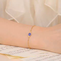 Elegant protective bracelet with blue evil eye on delicate gold chain