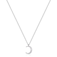 Close-up of celestial necklace featuring moon and star charms on fine chain