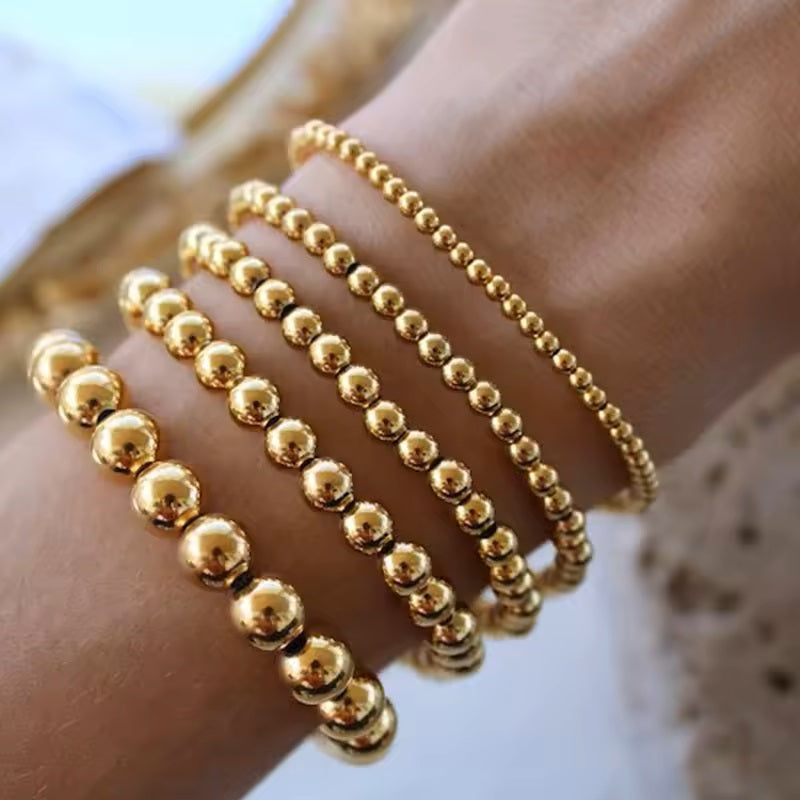 Gold plated beaded stretch bracelet with polished round beads 