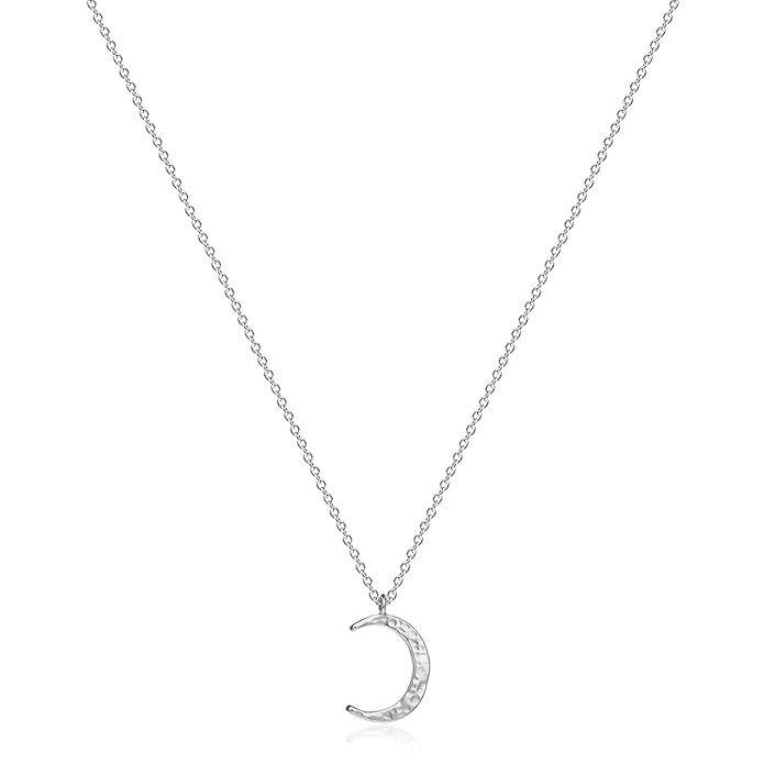 Close-up of celestial necklace featuring moon and star charms on fine chain